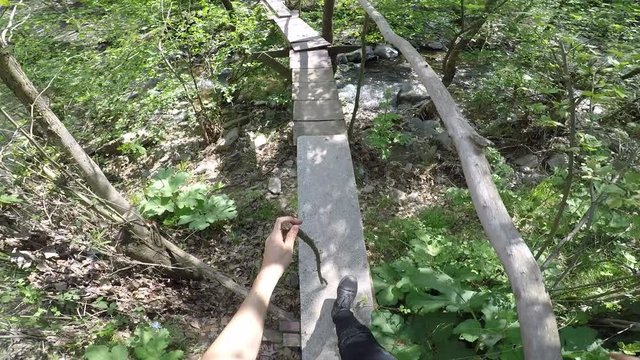 Someone crosses the old bridge in the forest and recording video by head camera. Armutlu Kemalpasa Aegean Izm?r Turkey