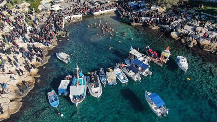 Aerial drone photo of famous Christian ceremony of Epiphany in small port of Aphrodite, with iconic small chapel of Agios Nikolaos, Piraeus, Attica, Greece