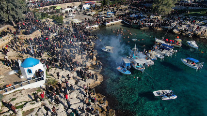 Aerial drone photo of famous Christian ceremony of Epiphany in small port of Aphrodite, with iconic small chapel of Agios Nikolaos, Piraeus, Attica, Greece