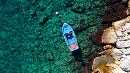 Aerial drone top view photo of traditional fishing boat in famous old harbour of Mykonos island, Cyclades, Greece