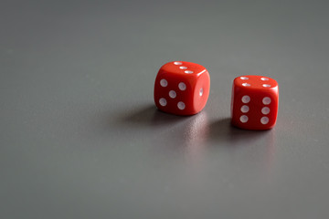 Two red dice isolated on grey background.