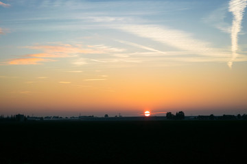 The sun sets over the dutch countryside.  Photograph was taken on an autumn day in the Green Heart of Holland: the area between the cities of Amsterdam, Rotterdam, The Hague and Utrecht.
