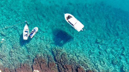 Aerial drone top view photo of traditional fishing boat in famous old harbour of Mykonos island, Cyclades, Greece - obrazy, fototapety, plakaty