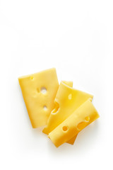 Sliced swiss cheese isolated on a white background viewed from above. Top view