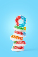 Sweet gymmy candy stacked on a blue background. Sweets concept