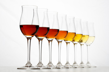 Row of cognac glasses with different stages of aging - 242468116