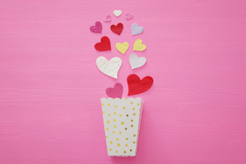 Valentine's day concept. Paper hearts over wooden pink background. Flat lay.