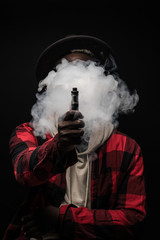 Young african man with cloud of smoke on face vape electronic cigarette cloud by using a mod, smoke...