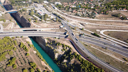 Aerial bird's eye view photo taken by drone of Corinth Canal of Isthmos or Isthmus and road network motorway connecting mainland with Peloponnese, Greece