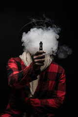 Young african man with cloud of smoke on face vape electronic cigarette cloud by using a mod, smoke...
