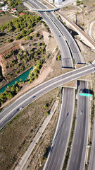 Obraz premium Aerial bird's eye view photo taken by drone of Corinth Canal of Isthmos or Isthmus and road network motorway connecting mainland with Peloponnese, Greece