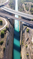 Aerial bird's eye view photo taken by drone of Corinth Canal of Isthmos or Isthmus and road network motorway connecting mainland with Peloponnese, Greece