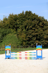 Colorful photo of equestrian obstacles. Empty field for horse jumping event competition