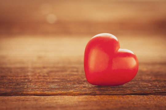 red heart on wooden board