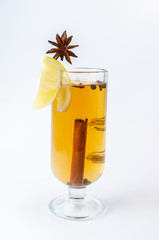 tea with cinnamon, lemon and star anise in a clear glass