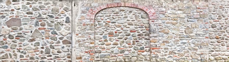 Old house wall with bricked door, in Tuscany.