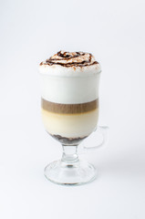 latte with cinnamon in a glass beaker on a white background
