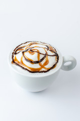 white cup of coffee with foam and caramel