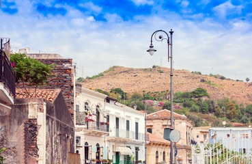 Travel to Italy -  historical street of Acitrezza, Catania, Sicily, facade of ancient buildings.