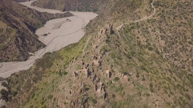Cinematic high angle 4k aerial of the ghost town of Amendolea, Calabria, Italy