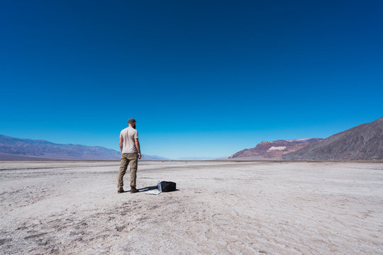 USA, California, Death Valley, back view of man standing in the desert