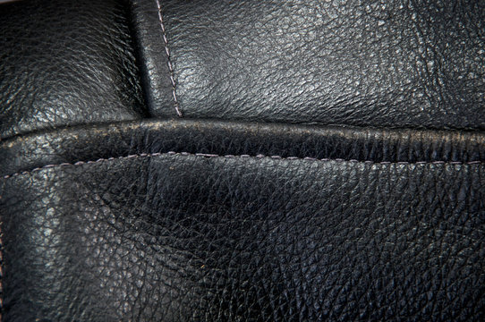 Detail Of Old Black Buffalo Leather Biker Jacket Focusing On Seams.