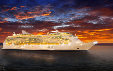 Luxury cruise ship sailing to port on sunset. 
