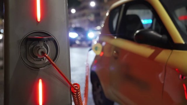 Charging of electric car. Eco energy, transport and power supply. 4K.