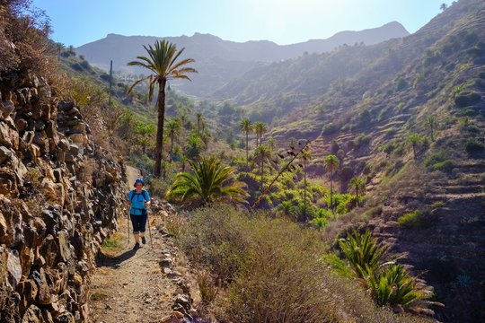 Woman hiking on trail in the Barranco de Simancas, near Vallehermoso, La Gomera, Canary Islands, Spain, Europe