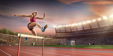 Female Track and field athlete jumps over the barrier at the running track in professional stadium