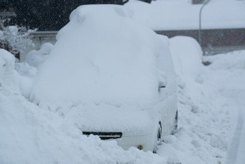 Snow on cars after snowfall. Winter urban scene.