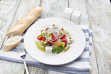 Greek salad with fresh vegetables, feta cheese and black olives
