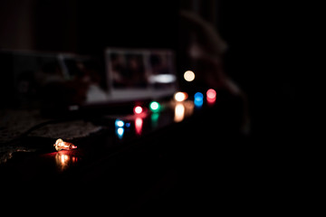Colourful holidays light bulbs on a dark background spotlights