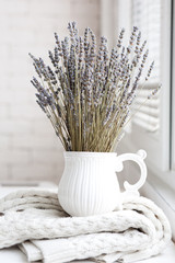 Fragrant lavender flowers in the room on the table near the window