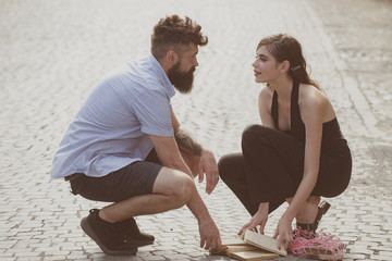 Love at first sight. Man and woman falling in love. Bearded man and cute woman met on street. Hipster helping and looking at pretty girl. Couple in love on summer day. Enjoy romantic date and dating