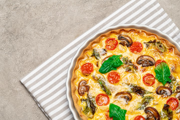 Baked homemade quiche pie in ceramic baking form