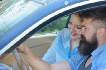 Electric car and ecology. Loving couple enjoy sustainable travel. Couple in love travel by automobile transport. Bearded man and sexy woman driving car. Using sustainable transport for zero pollution