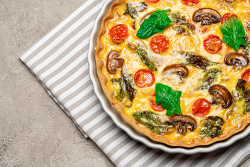 Baked homemade quiche pie in ceramic baking form