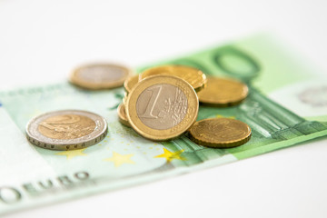 Euro coins on a paper bill