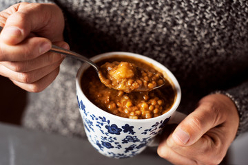 man eating a lentil soup