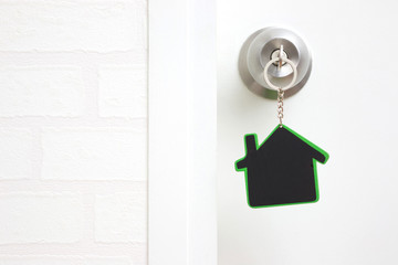 Symbol of the house and stick the key in the keyhole with copy space