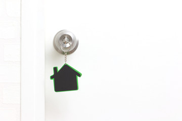 Symbol of the house and stick the key in the keyhole with copy space