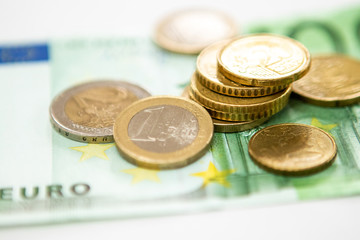 Euro coins on a paper bill