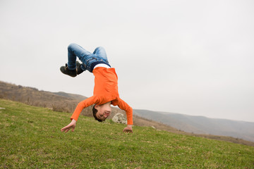 healthy sport little caucasian boy jumping flying in air outdoors mountain training copyspace