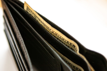 One dollar bill in a black leather wallet
