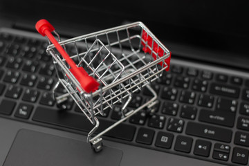 Small shopping cart on laptop for shopping online. Online shopping concept.