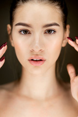 Portrait of young beautiful  brown-haired girl with natural makeup