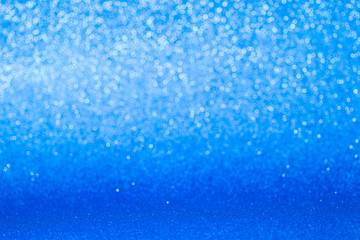 Fototapeta na wymiar Blue glitter christmas abstract background. Winter christmas bokeh lights defocused.