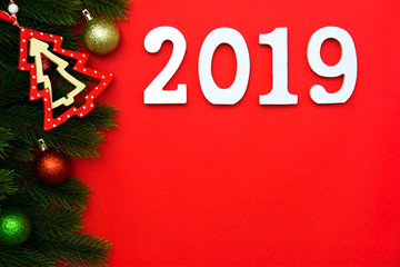 Holiday's background decorate with Christmas tree, fir branchs and bauble decoration. Happy New Year 2019. Flat lay.