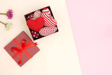 Flat lay of red pillows heart in gift box with copy space. Love and Valentine's day concept. Minimal style.
